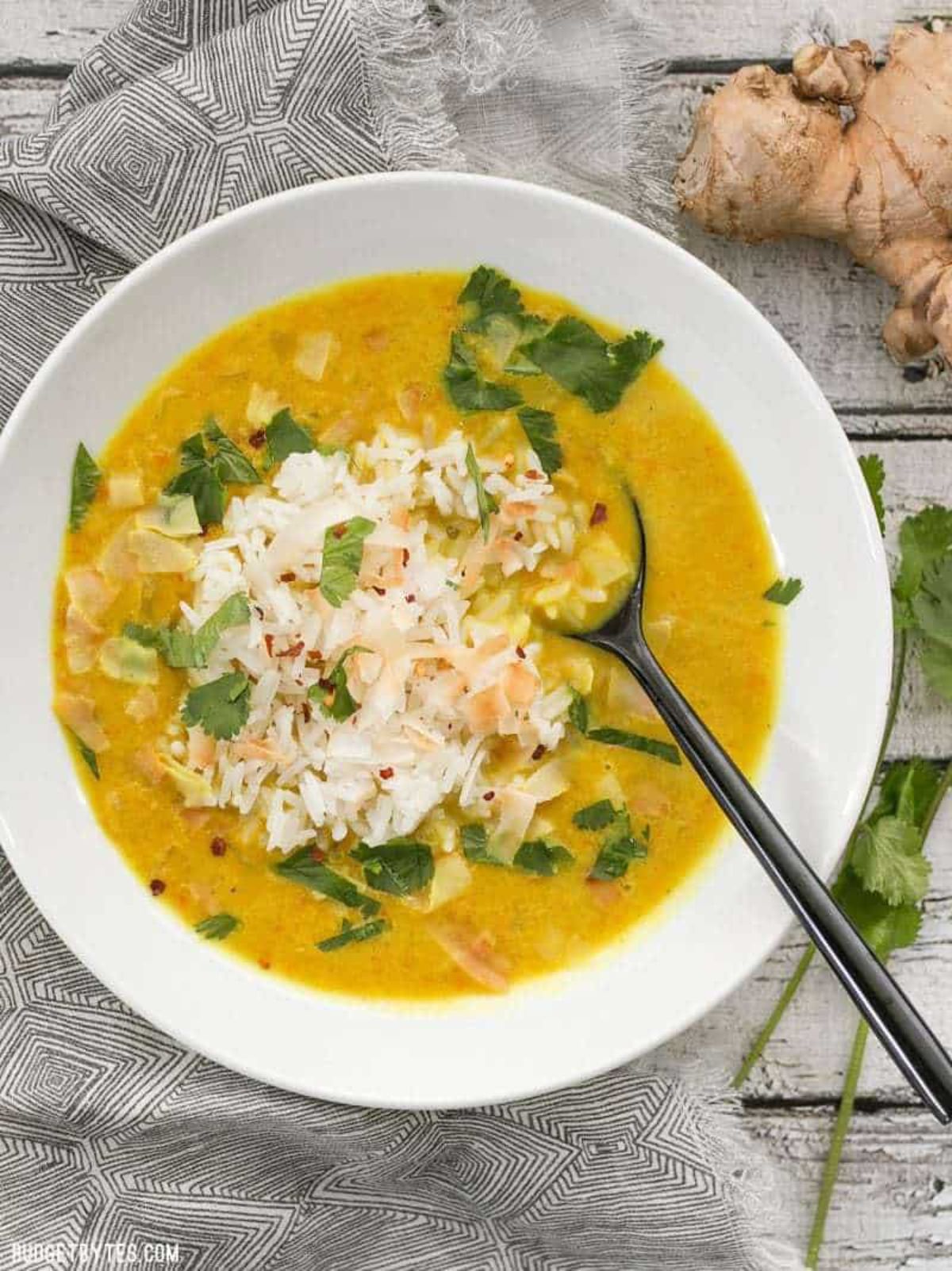 a white bowl full of golden coconut soup