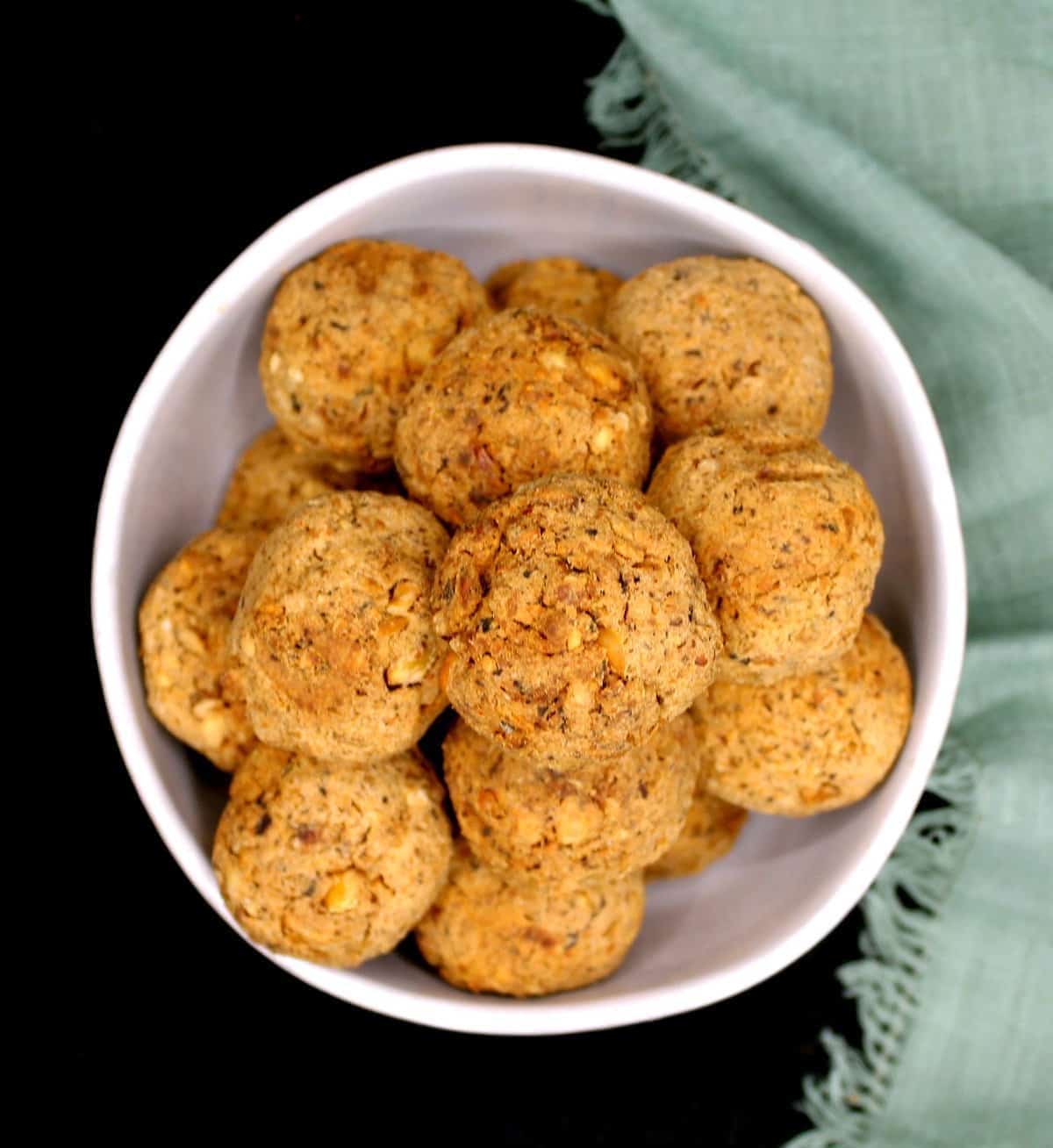 a top view of a white bowl full of meatballs