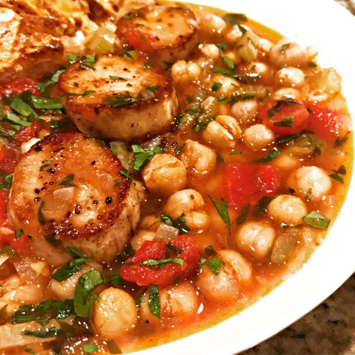 a white bowl of king oyster cioppino