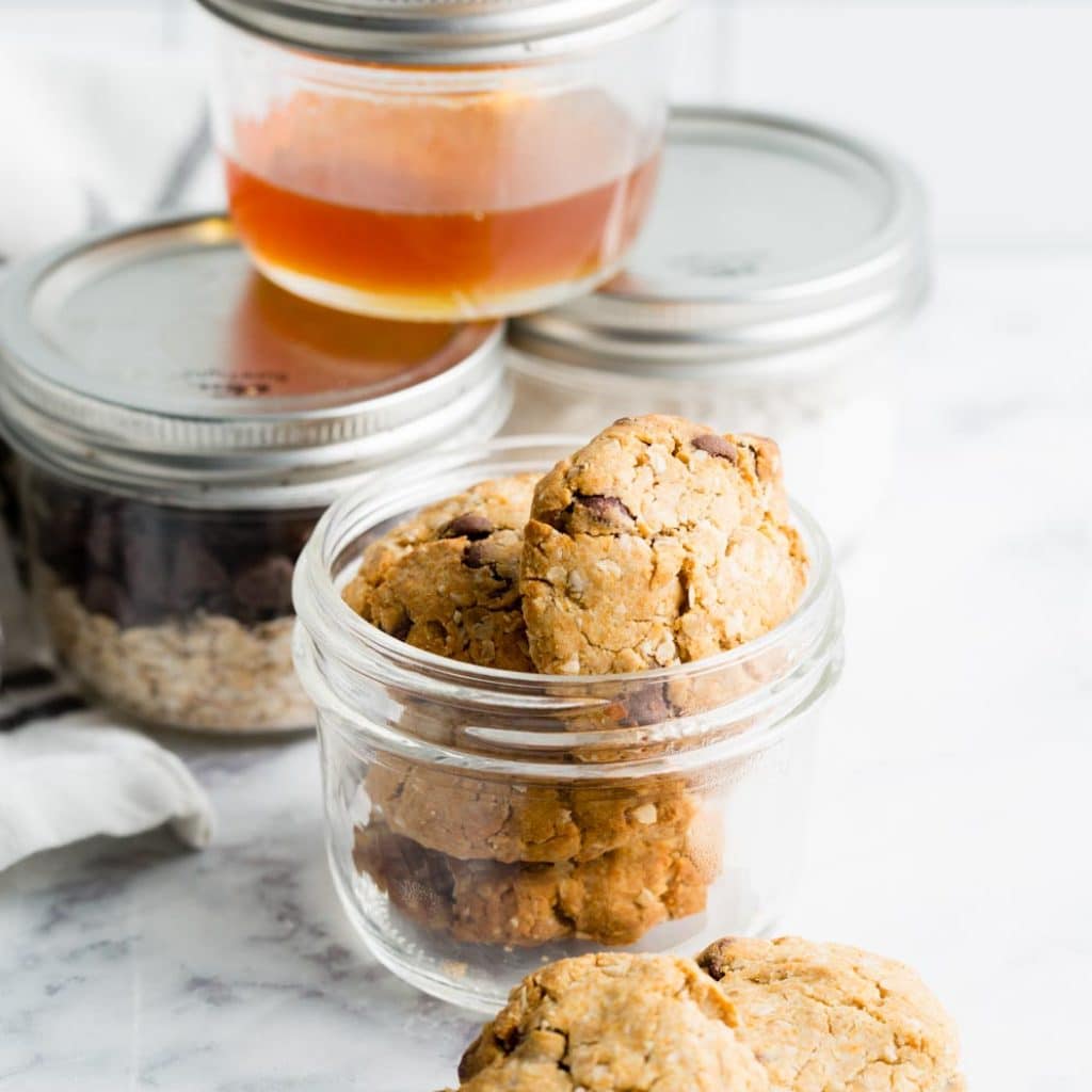 Oatmeal Cookies in Jar with ingredients in jars in the background