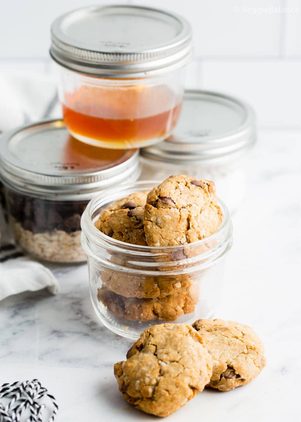 Oatmeal Cookies in Jar with ingredients in jars in the background