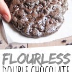 PINTEREST IMAGE with words "Flourless Double Chocolate Chip Cookies" Flourless Double Chocolate Chip Cookies being lifted off a pile.