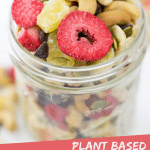 PINTEREST IMAGE with words "Plant Based Banana Split Trail Mix" Image Banana Split Trail Mix in a glass jar with overflow spread around,