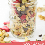 PINTEREST IMAGE with words "Plant Based Banana Split Trail Mix" Image Banana Split Trail Mix in a glass jar with overflow spread around,