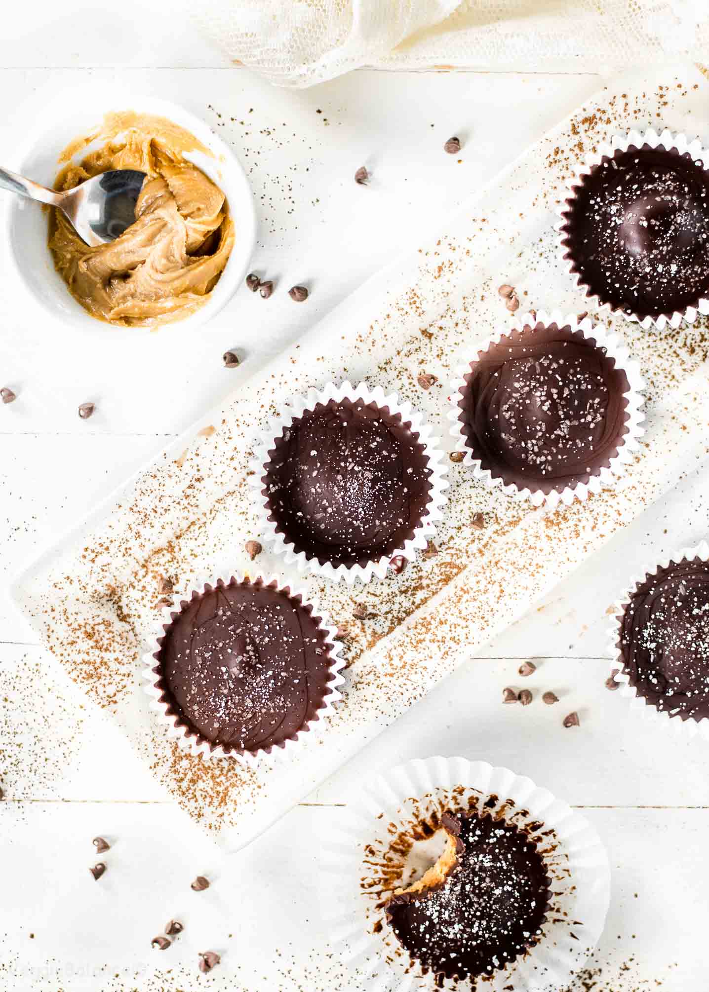 Homemade Peanut Butter Cups Overhead with Cup of Peanut Butter and Cocoa Powder