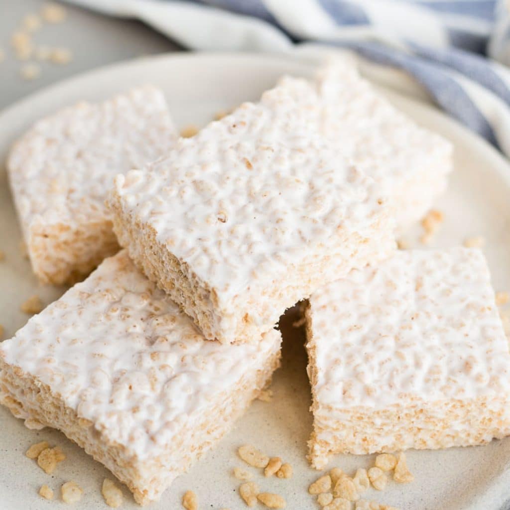 Gluten Free Rice Krispie Treats on a plate with one stacked on top the others