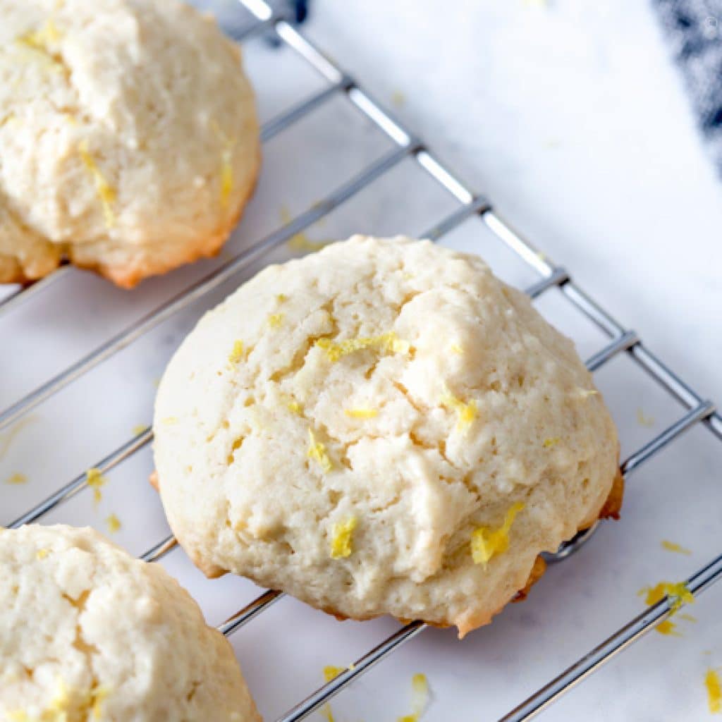 Lemon Gluten Free Cookies with lemon zest on top on a cooling rack