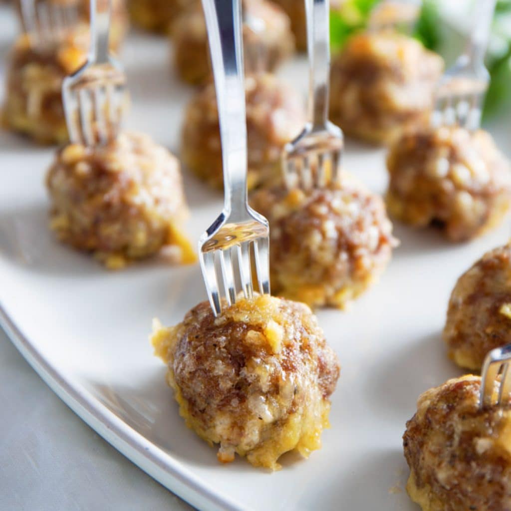 Gluten Free Meatballs with small forks sticking out the top on a white dish