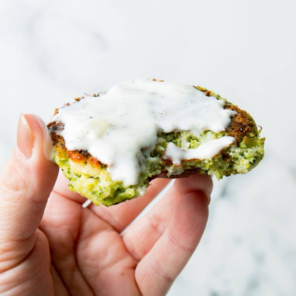 Broccoli Fritters with white sauce being held
