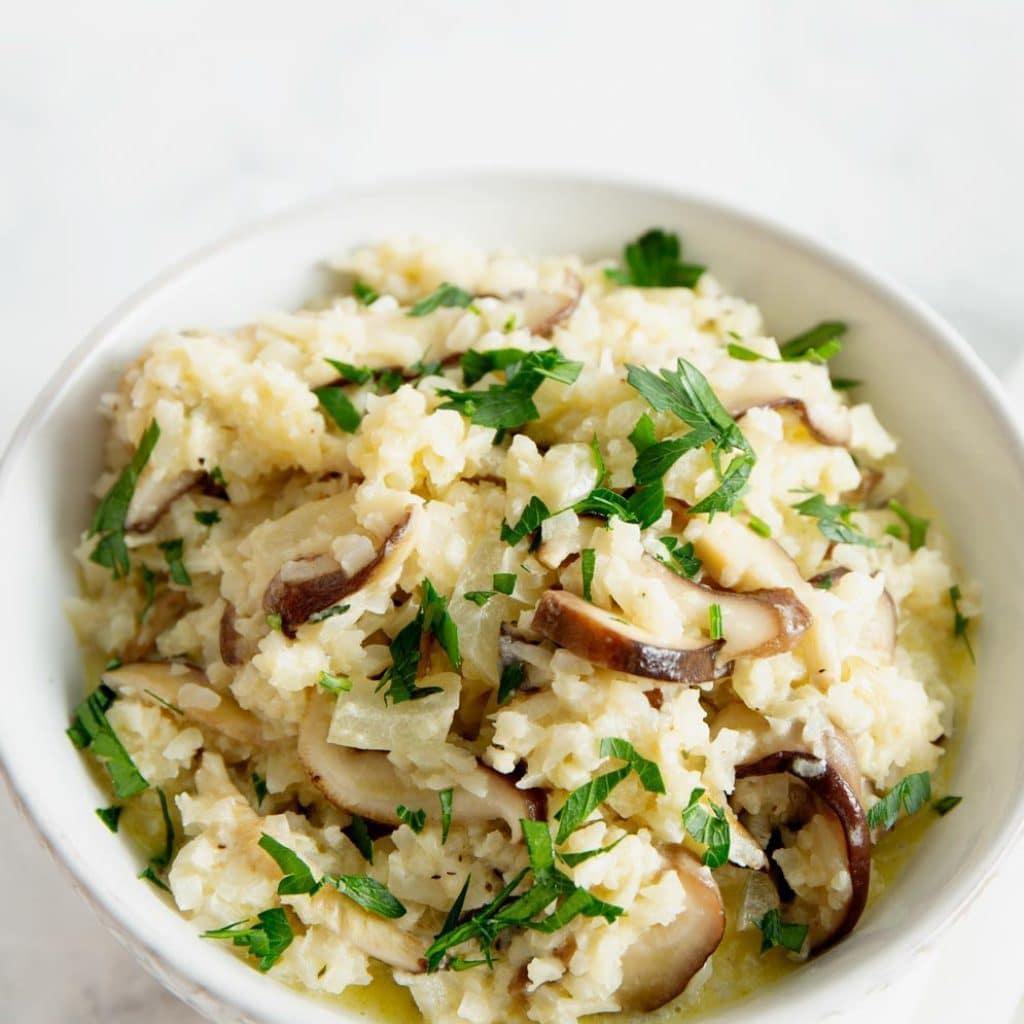 Vegan Cauliflower Mushroom Risotto in a white bowl