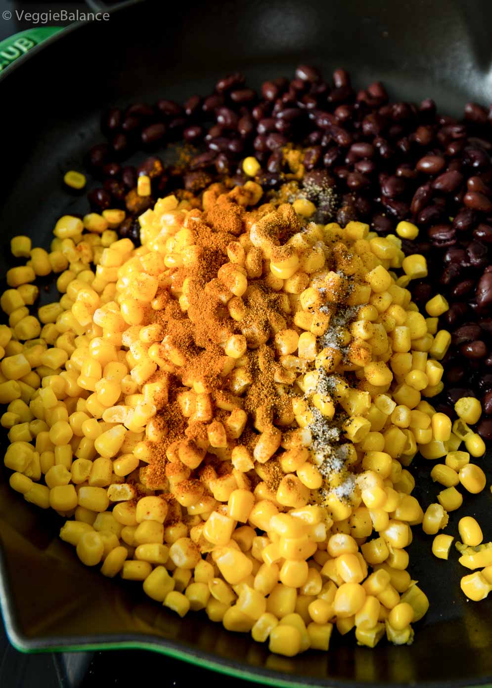 Black Beans and Corn in skillet with seasoning. It will be our protein of our vegan burrito bowl