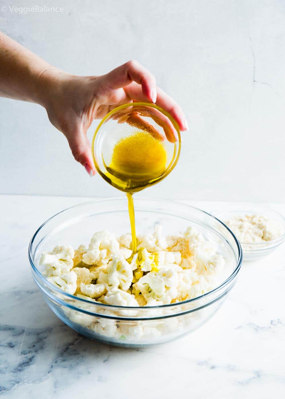 Pouring Olive Oil over roasted cauliflower