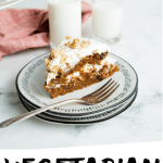 PINTEREST IMAGE with words "Vegetarian Carrot Cake" Vegetarian Carrot Cake slice with white frosting on a white plate with a glass of milk.