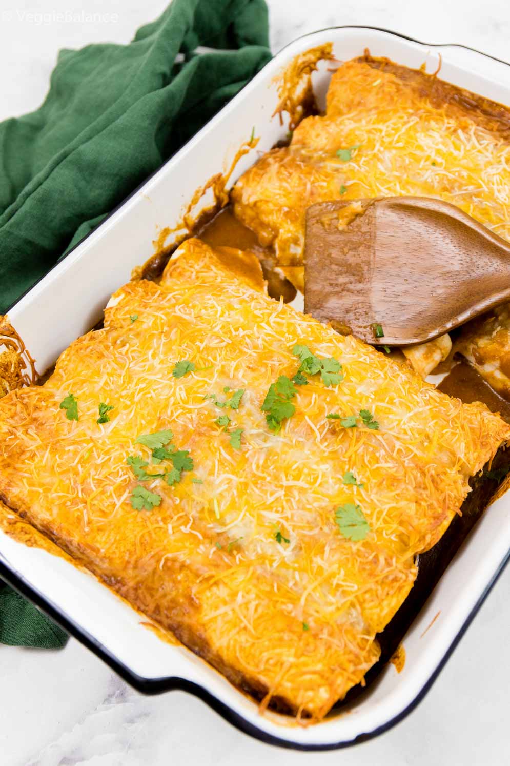 Black Bean Enchiladas cooked and in a white casserole dish ready to be served