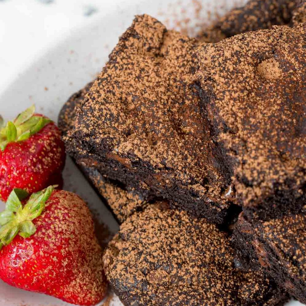 Plate of Vegan Brownies with strawberries on the side