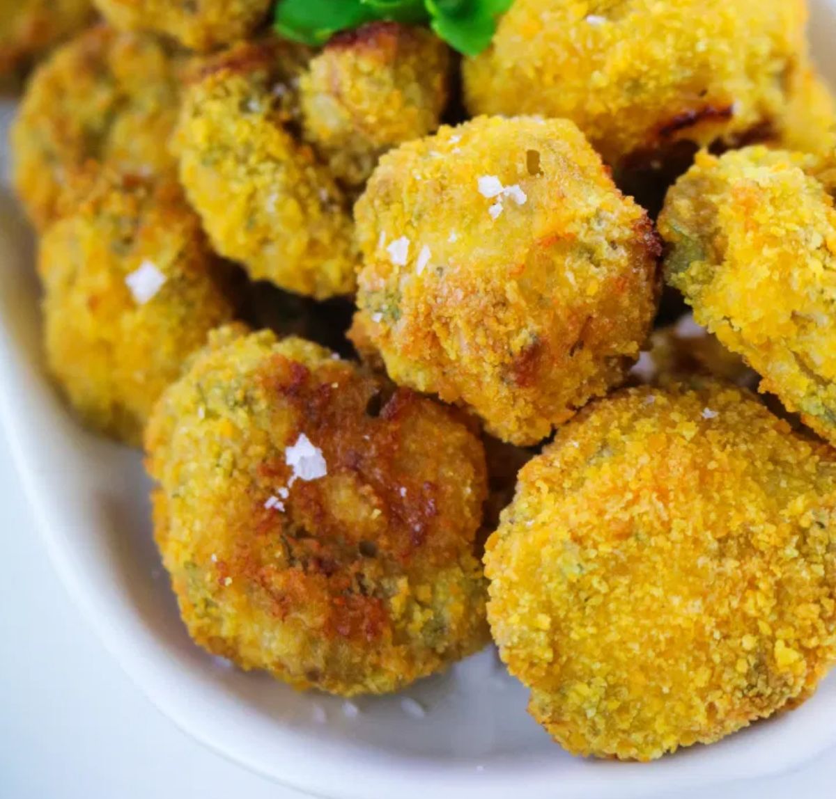 a close up of a dish full of garlic mushrooms