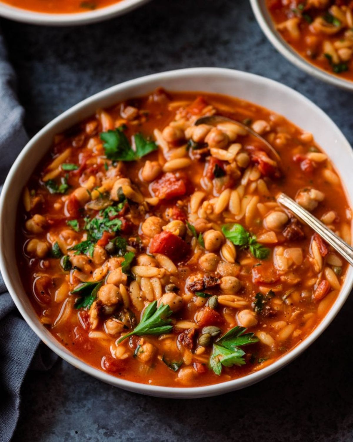 a bowl full of chickpea orzo soup