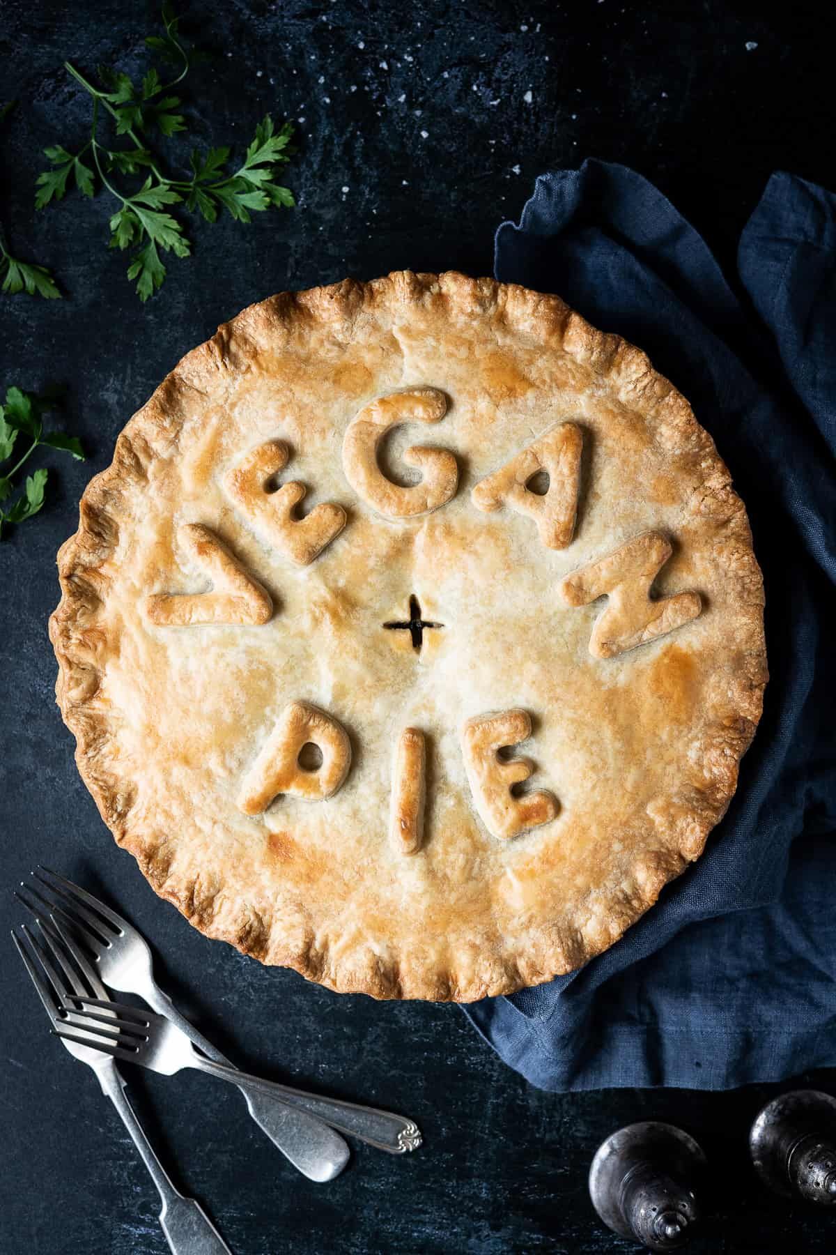 looking down at a vegan chickpea leek and nushroom pie with the words "vegan pie" created on the lid in pastry