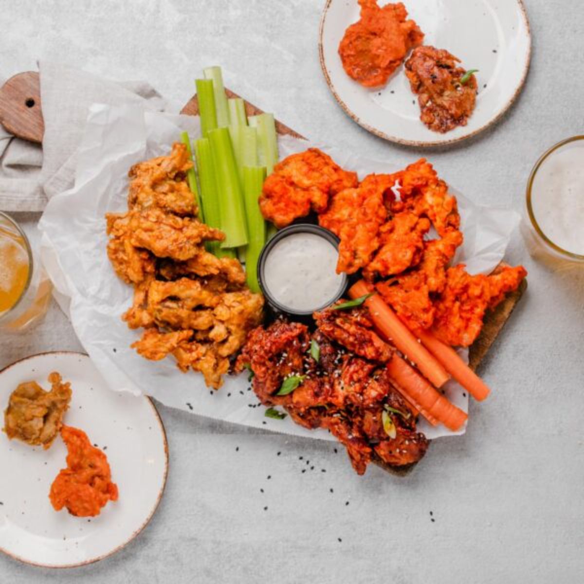 vegan mushroom wings, with celery and carrot sticks and a creamy dip