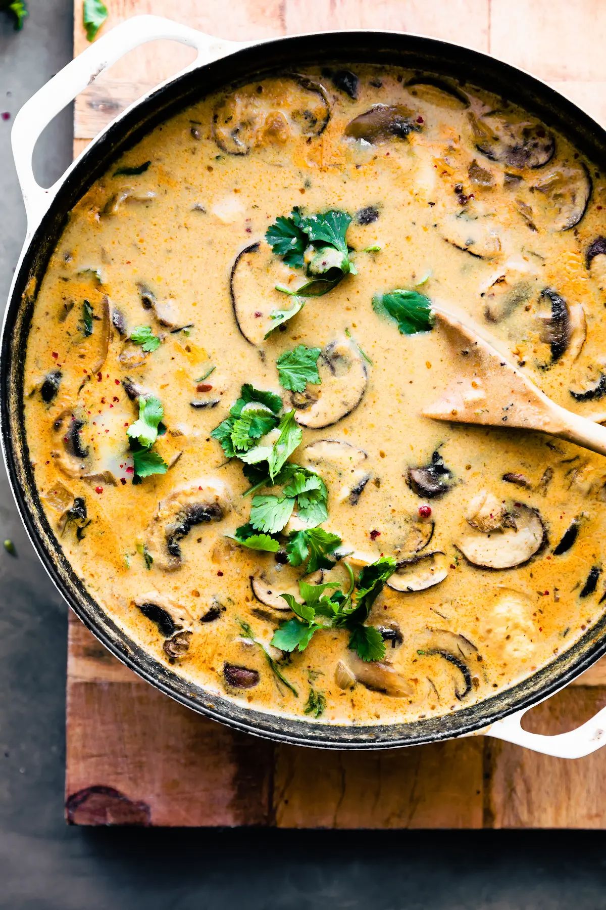 a cast iron pan full of orange creamy mushroom soup