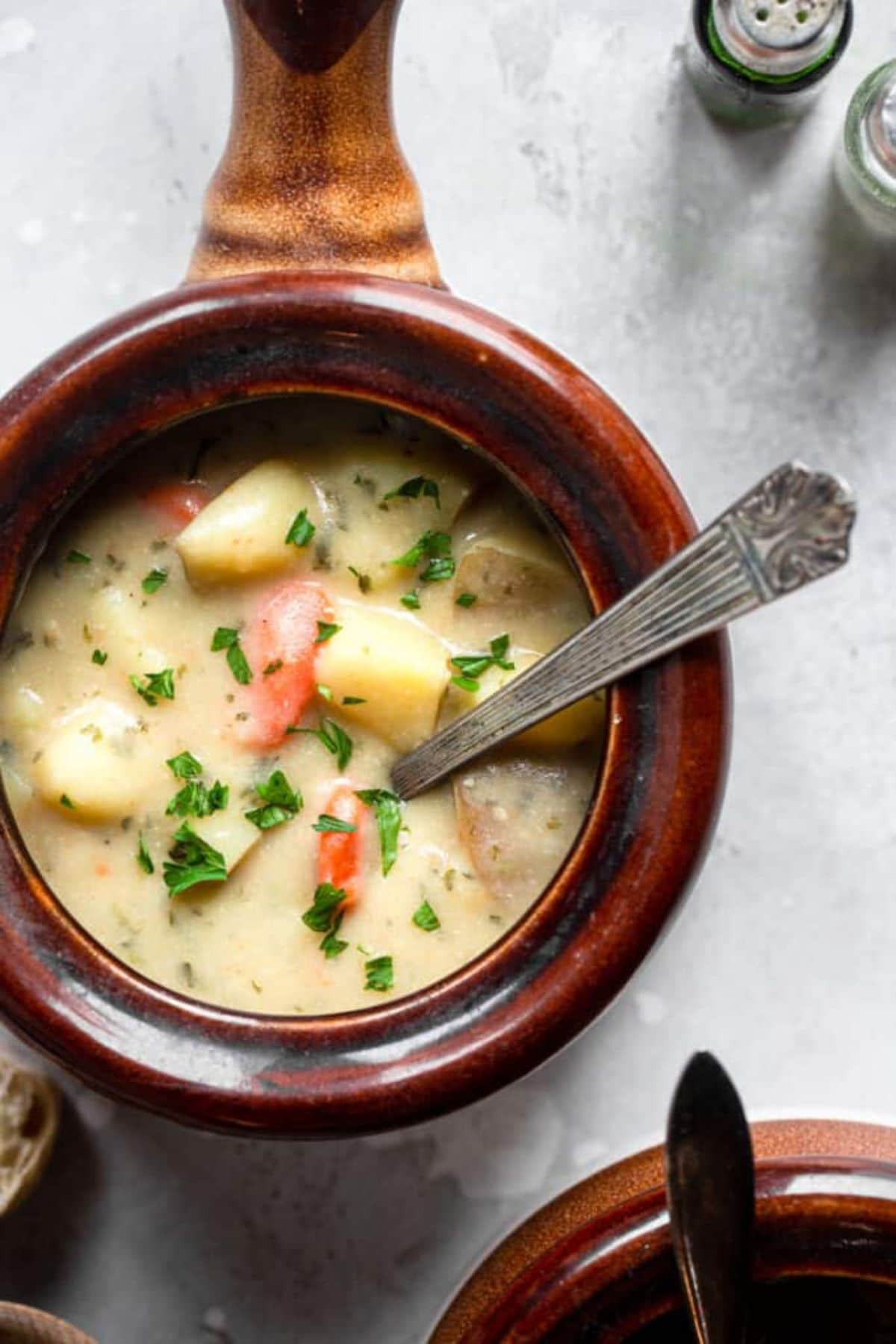 a wooden bowl full of potato soup