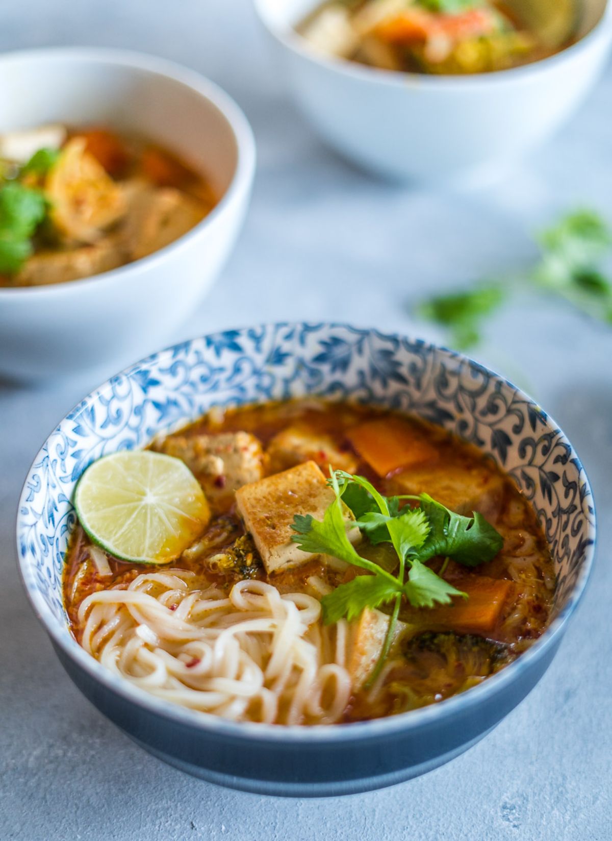 3 bowls full of thai coconut noodle soup