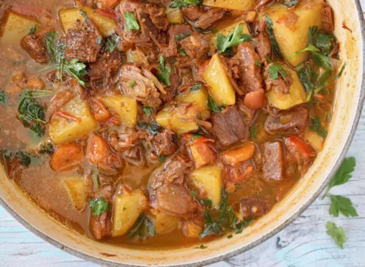 a close up of a cast iron casserole dish full of jackfruit stew