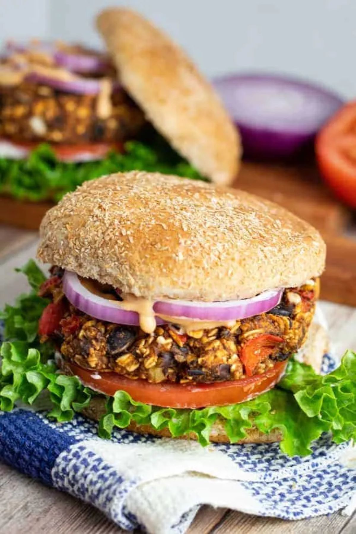 a black bean patty with salad in a bun.