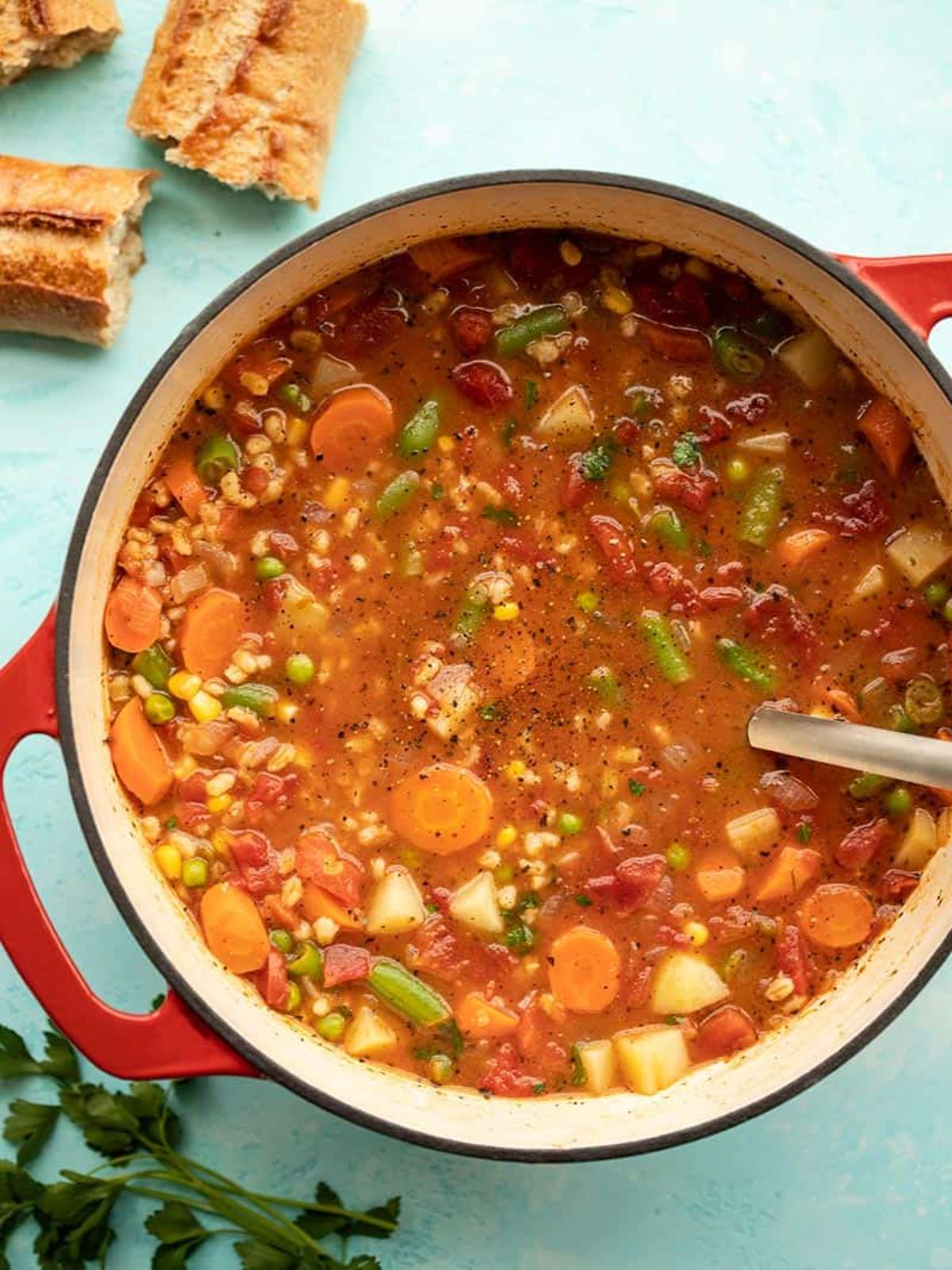 a large casserole dish filled with vegetable barley soup